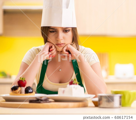 Young cook cooking cakes in the kitchen 68617154