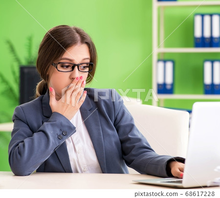Young female employee very busy with ongoing paperwork 68617228