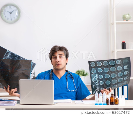 Male doctor radiologist with x-ray can image Male doctor radiologist with x-ray can image 68617472