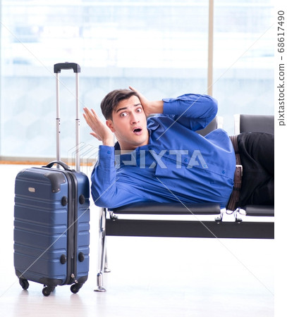 Man wairing to boarding in airport lounge room 68617490