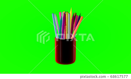 Rotating glass with colored pencils on a green Rotating glass with colored pencils on a green 68617577