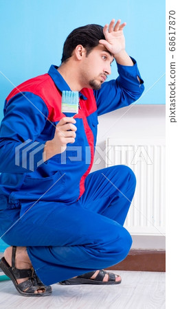 Young painter doing renovation at home Young painter doing renovation at home 68617870