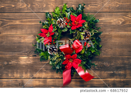 Amazing Christmas wreath with big red bow on wooden background 68617932