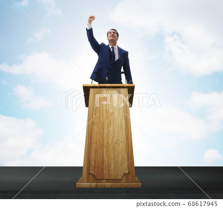 Man businessman making speech at rostrum in business concept Man businessman making speech at rostrum in business concept 68617945