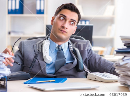 Desperate sad employee tired at his desk in call center Desperate sad employee tired at his desk in call center 68617989