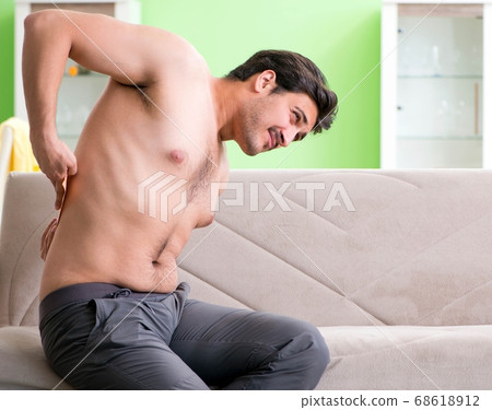 Man applying pepper Capsicum plaster to relieve pain 68618912