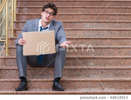 Desperate businessman begging on the street Desperate businessman begging on the street 68618913