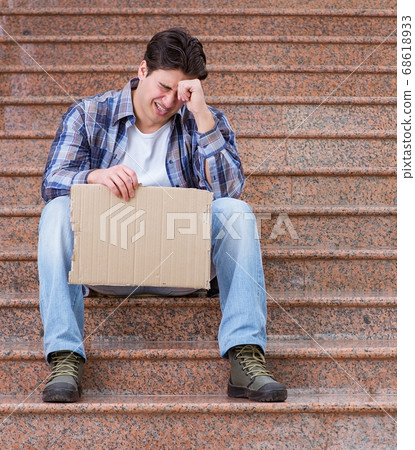 Young man begging money on the street Young man begging money on the street 68618933