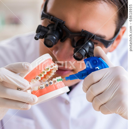 Young dentist working in the dentistry hospital Young dentist working in the dentistry hospital 68618935