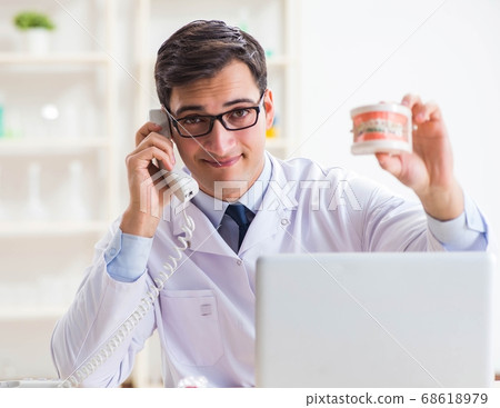 Young dentist working in the dentistry hospital 68618979