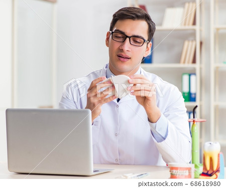 Young dentist working in the dentistry hospital 68618980