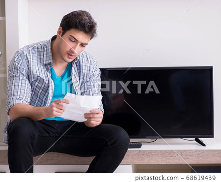 Man trying to fix broken tv Man trying to fix broken tv 68619439