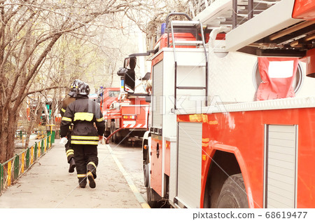 Fire with black smoke in multistory apartment building. Toned Fire with black smoke in multistory apartment building. Toned 68619477