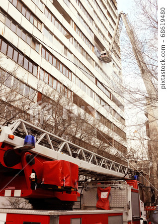 Fire with black smoke in multistory apartment building. Toned Fire with black smoke in multistory apartment building. Toned 68619480