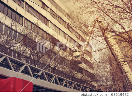 Fire with black smoke in multistory apartment building. Toned 68619482