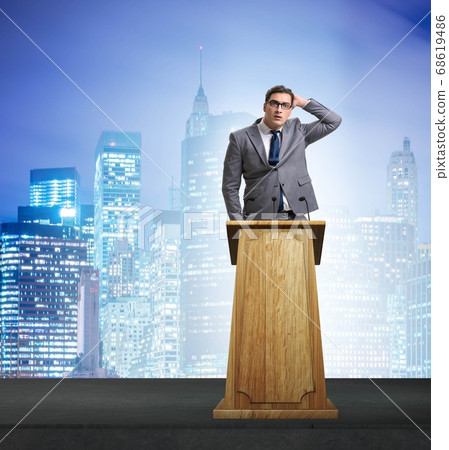 Man businessman making speech at rostrum in business concept Man businessman making speech at rostrum in business concept 68619486