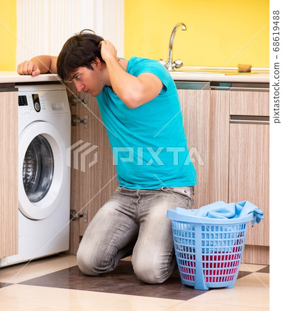 Young husband man doing laundry at home Young husband man doing laundry at home 68619488
