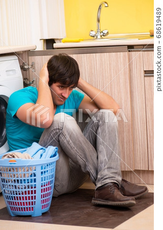 Young husband man doing laundry at home Young husband man doing laundry at home 68619489