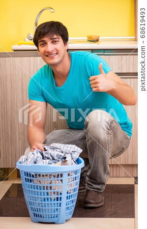 Young husband man doing laundry at home Young husband man doing laundry at home 68619493