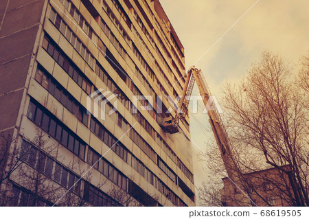 Fire with black smoke in multistory apartment building. Toned Fire with black smoke in multistory apartment building. Toned 68619505