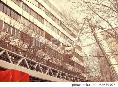 Fire with black smoke in multistory apartment building. Toned Fire with black smoke in multistory apartment building. Toned 68619507