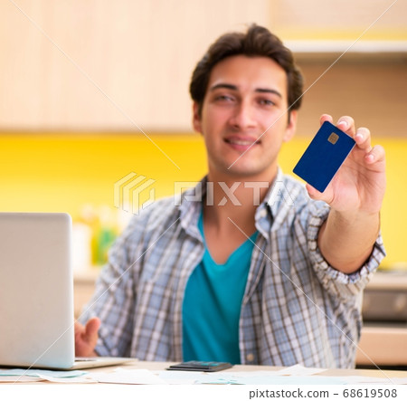 Young man husband in budget planning concept Young man husband in budget planning concept 68619508