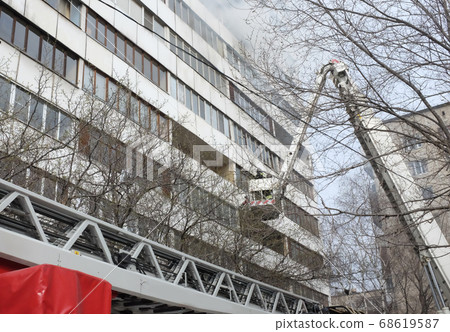 Fire with black smoke in multistory apartment building. Fire with black smoke in multistory apartment building. 68619587
