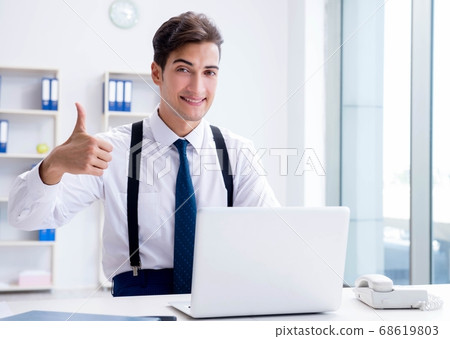 Young stylish businessman working in the office Young stylish businessman working in the office 68619803