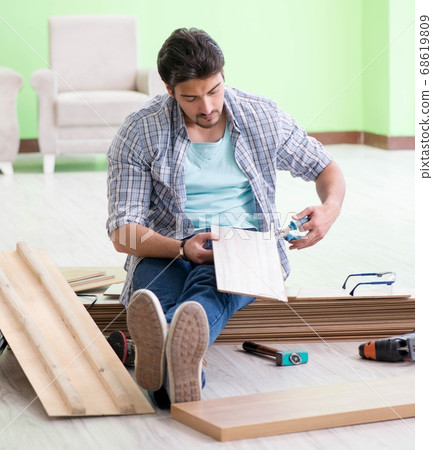 Man laying flooring at home 68619809