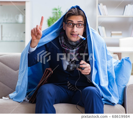 Employee suffering from flue playing computer game at home 68619984