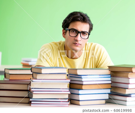 Student with too many books to read before exam 68619998