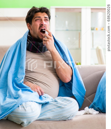 Sick young man suffering from flu at home 68620026