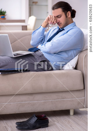 Tired businessman employee working from home Tired businessman employee working from home 68620683