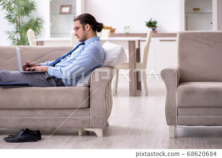 Tired businessman employee working from home Tired businessman employee working from home 68620684