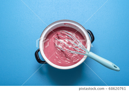 Ruby chocolate melted in a pot. Pink chocolate Ruby chocolate melted in a pot. Pink chocolate 68620761