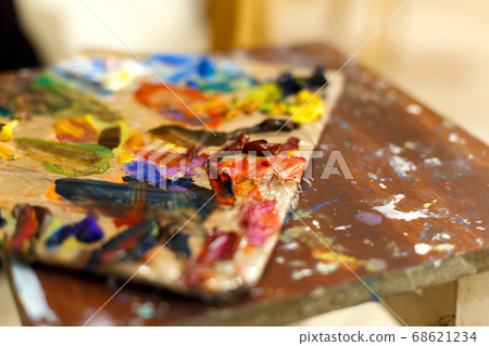 Close-up of an easel with paints, the artist 68621234