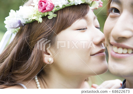 Bride kissing the cheek of the groom 68622673