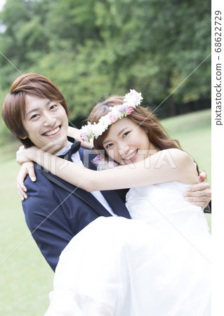 Bride and groom holding a princess Bride and groom holding a princess 68622729