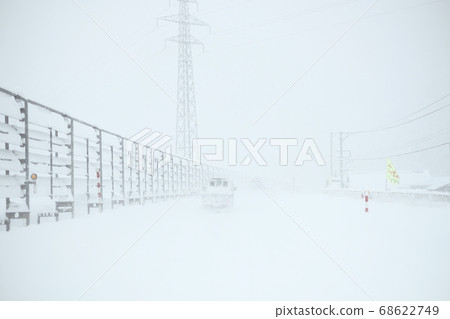 A light truck running through a snowstorm in winter A light truck running through a snowstorm in winter 68622749