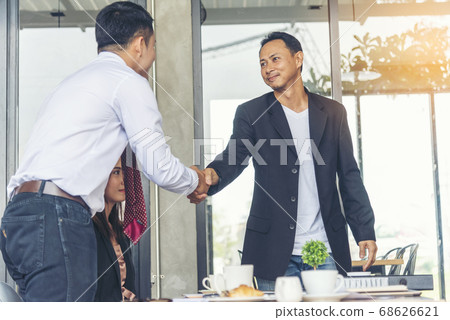 Team Business Partners shaking hands together to 68626621