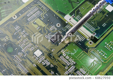 soldering iron for repairing electronic of the computer circuit board concept technology of computer circuit hardware. soldering iron for repairing electronic of the computer circuit board concept technology of computer circuit hardware. 68627050