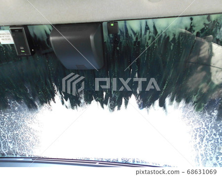 View from inside the car (driver's perspective) of the brushes of an automatic car wash approaching View from inside the car (driver's perspective) of the brushes of an automatic car wash approaching 68631069