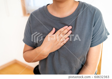 Female in her 30s showing a lump in her chest 68632363