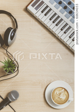 piano, cup of coffee, headphone, microphone and plant on wooden floor. film look. relaxation concept 68634033