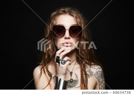 beauty tattooed girl in sunglasses and jewelry 68634736