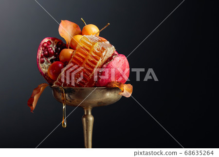 Ripe pomegranate fruits with wild apples and honey Ripe pomegranate fruits with wild apples and honey 68635264