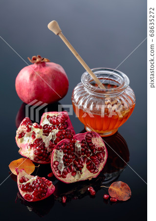 Ripe pomegranate fruits with honey and dried up Ripe pomegranate fruits with honey and dried up 68635272
