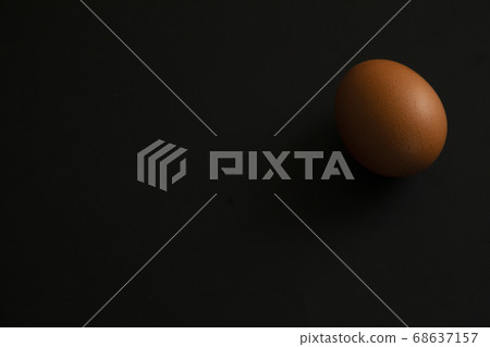 Raw egg on black background 68637157