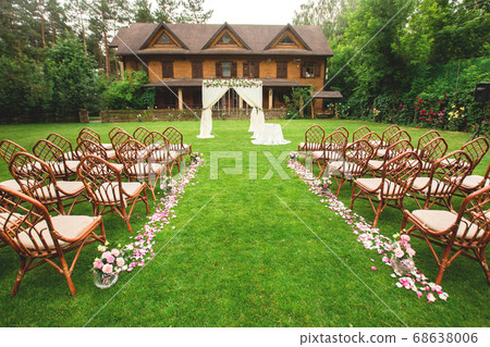 Outdoor wedding ceremony decoration setup. Path 68638006
