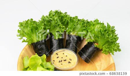 seaweed asian salad rolls in wooden bowl 68638139